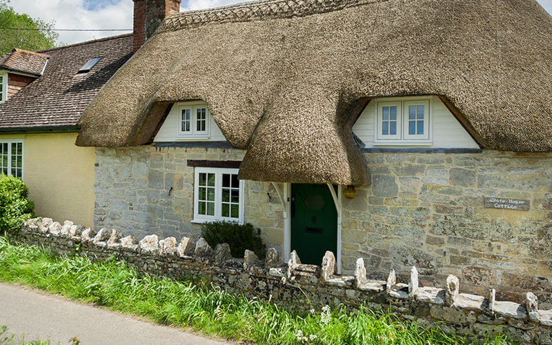 Flush sash windows on a thatched cottage